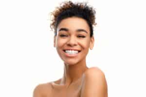 A woman smiling after experiencing the HydraFacial Syndeo™