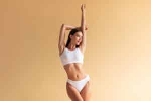 Woman showing her slim, contoured body from liposuction in East Greenwich, RI