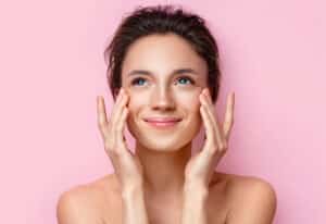 Smiling woman with glowing skin from medical-grade facial in East Greenwich, RI